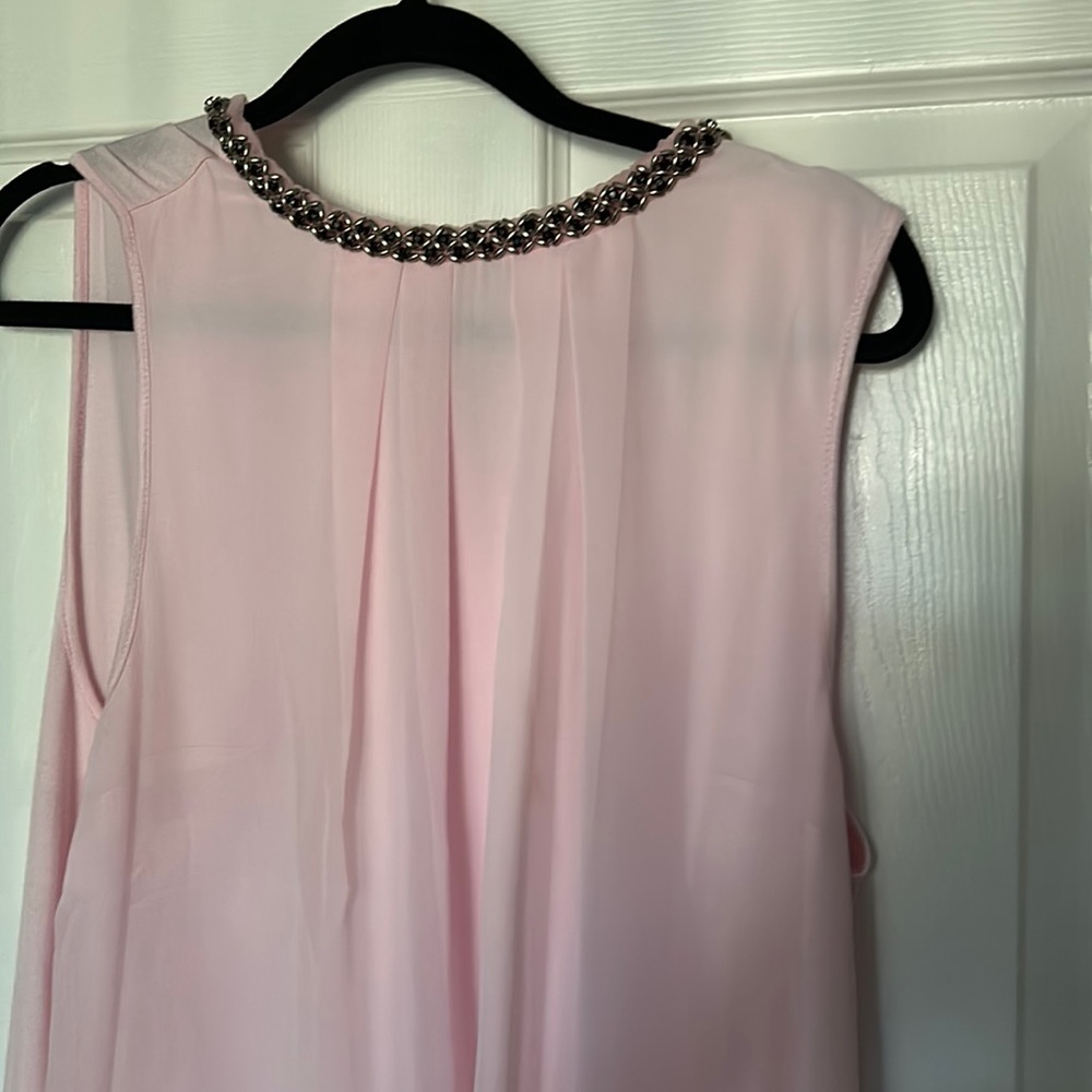 Feminine sleeveless blouse with jeweled neckline